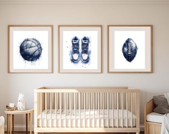May include: Three framed prints in a nursery setting. The prints are in a blue watercolor style and feature a basketball, a pair of sneakers, and a football.