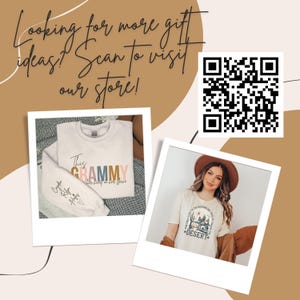May include: Two white t-shirts with different designs. The first shirt has the text "This Grammy" in colorful letters and the text "her heart is on her sleeve" in smaller letters. The second shirt has the text "Some say life is the adventure, some say it's the journey, but I say it's the *DESERT*" with a graphic of a desert scene.  A QR code is in the upper right corner of the image. The text "Looking for more gift ideas! Scan to visit our store!" is in the upper left corner of the image.