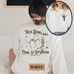 May include: White sweatshirt with a graphic of two skeletons dancing with the text "These bones will come to life again Ezekiel 37:4-5".