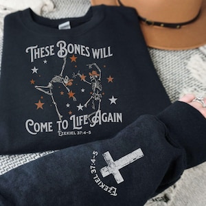 May include: Black sweatshirt with a white graphic print of two skeletons dancing with stars and the text "These bones will come to life again Ezekiel 37:4-5".