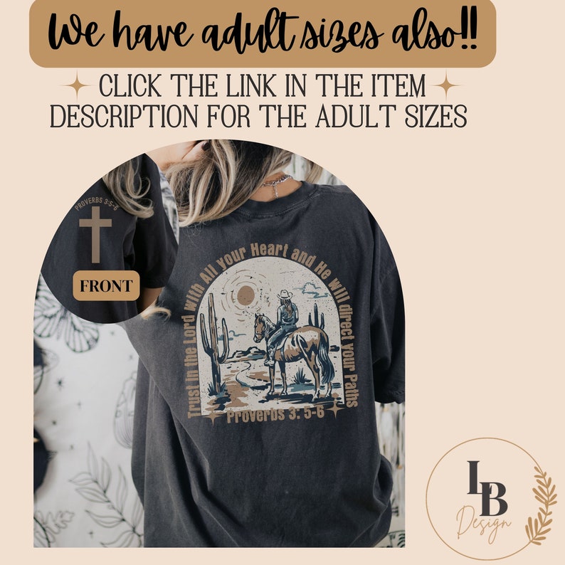 May include: A black t-shirt with a cross on the front and a design on the back. The design features a cowboy riding a horse in a desert landscape with the text "Trust in the Lord with All your Heart and He will direct your Paths" and "Proverbs 3:5-6".