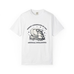 May include: White t-shirt featuring a black and white graphic of a frog wearing glasses sitting in front of a computer. The text reads "NOBODY UNDERSTANDS ME LIKE ARTIFICIAL INTELLIGENCE."
