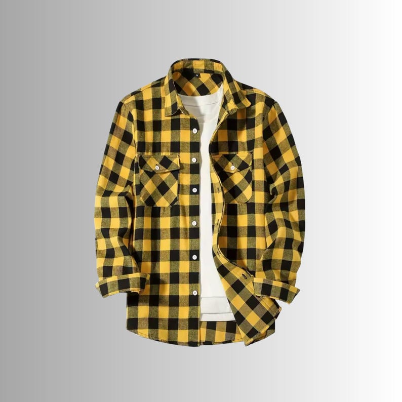 May include: Yellow and black plaid flannel shirt with two chest pockets and a button-down front. The long-sleeved shirt is displayed open, revealing a white undershirt. The shirt is made of a soft, woven fabric.