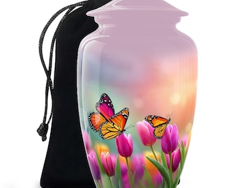 May include: A light pink cremation urn with a butterfly and tulip design. The urn features a glossy finish and a black drawstring bag. The butterflies are orange, pink, and black, and the tulips are pink.