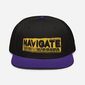 May include: A black and purple baseball cap with a yellow and black "NAVIGATE" graphic on the front.