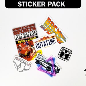 May include: A sticker pack featuring a variety of designs, including a sports almanac, a DeLorean time machine, a "Back to the Future" logo, a license plate that reads "OUTATIME", and a flux capacitor. The stickers are on a white background.