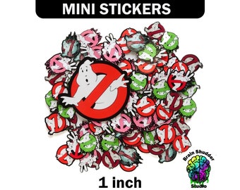 May include: A large pile of 1-inch Ghostbusters themed stickers. The stickers feature the Ghostbusters logo, the Stay Puft Marshmallow Man, and other Ghostbusters characters. The stickers are printed on white paper and have a glossy finish.