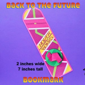 May include: A pink and green hoverboard bookmark with the text "HOVER BOARD" printed on it. The bookmark is 2 inches wide and 7 inches tall.