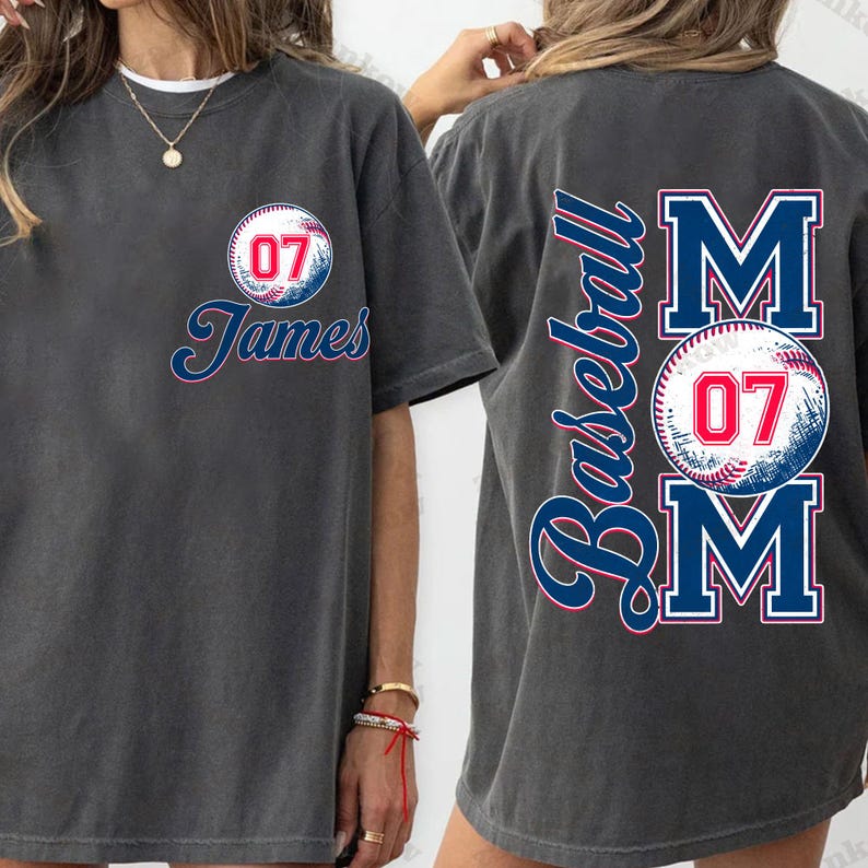May include: Two gray t-shirts with a baseball theme. One shirt has a baseball with the number 07 and the name "James" printed on it. The other shirt has the word "Baseball" and the word "MOM" with a baseball and the number 07 printed on it.