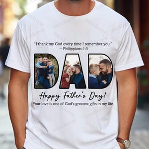 May include: White t-shirt with the word "DAD" in large black letters, each letter containing a family photo. The shirt also has the text "Happy Father's Day!" and a Bible verse.