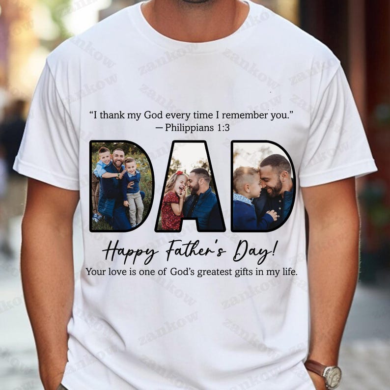 May include: White t-shirt with the word "DAD" in large black letters, each letter containing a family photo. The shirt also has the text "Happy Father's Day!" and a Bible verse.