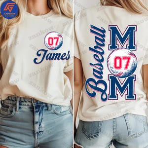 May include: Two white t-shirts with a baseball theme. One shirt has a baseball with the number 07 and the name James. The other shirt has the word "Baseball" and the word "MOM" with a baseball in between. The baseball has the number 07.