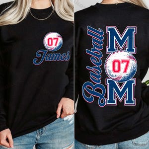 May include: Black sweatshirt with a baseball graphic and the text "Baseball Mom" and "07" in red. The sweatshirt also has the text "James" and "07" in white.