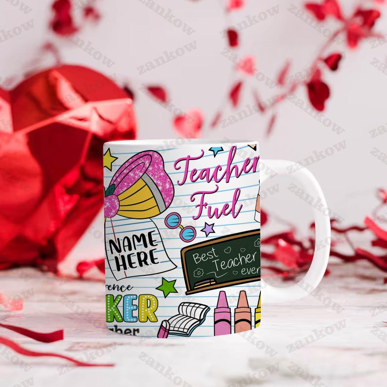 May include: White ceramic mug with a colorful design featuring the text "Teacher Fuel" and various school-themed illustrations. The mug includes a blackboard with the text "Best Teacher ever" and a space for a name.