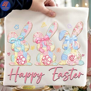 May include: A cream-colored Easter-themed pillow with three appliqued bunny rabbits. Each bunny has a patchwork design with floral patterns, bows, and a flower. The words "Happy Easter" are written in pink script.