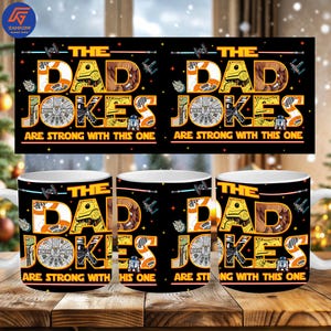 May include: White ceramic mugs with a black design featuring the text "THE DAD JOKES ARE STRONG WITH THIS ONE" in orange and brown, with Star Wars-themed graphics. The mugs are on a wooden surface.