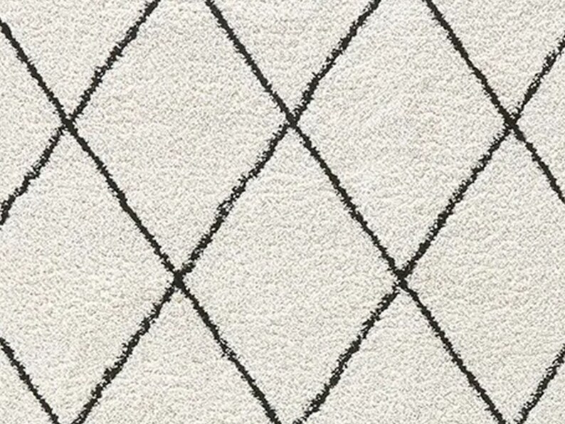 May include: A textured off-white fabric featuring a repeating diamond pattern formed by thin, dark charcoal lines. The surface has a slightly fuzzy, soft appearance with a consistent grid of intersecting diagonal lines across the material.