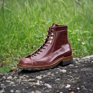 May include: A pair of brown leather lace-up boots with a thick sole. The boots have a classic design and are made of high-quality leather.