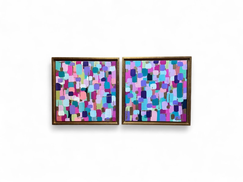 Peut inclure: Deux peintures abstraites encadr&eacute;es avec une bordure dor&eacute;e. Chaque peinture pr&eacute;sente un arrangement color&eacute; de coups de pinceau dans des tons de rose, de violet, de bleu et de vert. L'&oelig;uvre est expos&eacute;e sur un fond blanc.