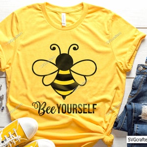 May include: Yellow t-shirt with a black and yellow bee graphic and the text "Bee Yourself".