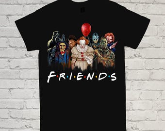 May include: Black t-shirt featuring a graphic of horror movie characters, including Pennywise, Jason Voorhees, and Freddy Krueger. The word "FRIENDS" is printed in a colorful, stylized font across the bottom of the shirt.