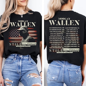 May include: Black t-shirt featuring a graphic of Morgan Wallen with an American flag design. The shirt includes tour dates and the text "STILL THE PROBLEM TOUR 2026".