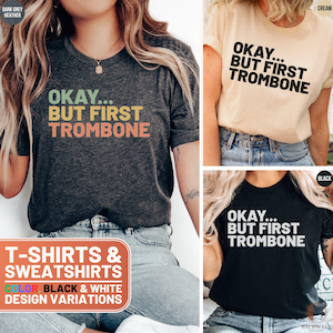 May include: Three t-shirts in different colors, dark grey heather, cream, and black, with the text "Okay... But First Trombone" printed on them. The t-shirts are available in black and white design variations.