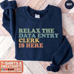 May include: Navy blue sweatshirt with the text "Relax the Data Entry Clerk is Here" in a retro rainbow color scheme.