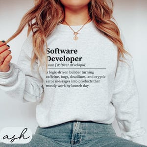 Grey sweatshirt with "Software Developer" definition text and "ash" logo.