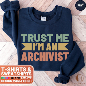 May include: Navy blue sweatshirt with the text "TRUST ME I'M AN ARCHIVIST" in a retro font with colorful accents. The sweatshirt is available in black and white design variations.