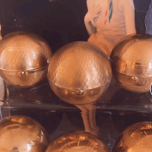 Rare, fabulous 1950&#39;s Pygmalion sphere powder compact.  This delightful spherical compact with pretty engine turned deco. Puff and screen.