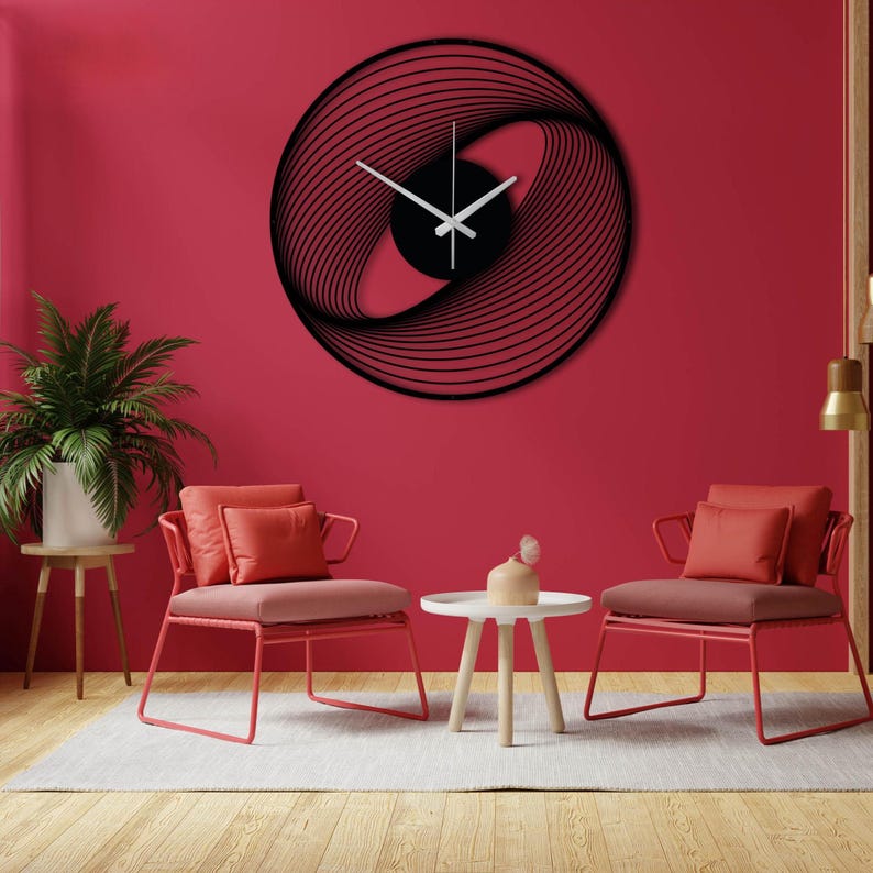 May include: Black, modern wall clock with a unique, abstract design. The clock features a circular frame with swirling lines and white clock hands. The clock is mounted on a red wall.