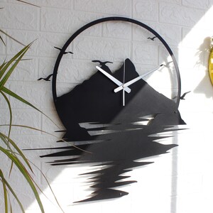 Nature wall art clock displayed above console table in cozy living room