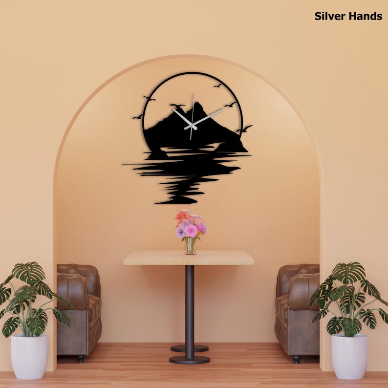 May include: A circular wall clock featuring a black silhouette of a mountain range and birds against a circular frame. The clock has silver hands and displays the text Silver Hands in the upper right corner. The design includes a reflection effect.