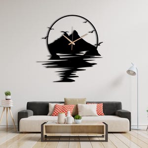 Large metal wall clock with birds, mountains and reflective water scene