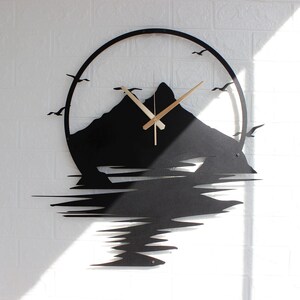 Rustic cabin wall clock featuring mountain silhouette and lake reflection artwork