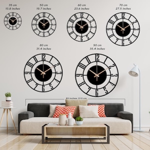 Op de afbeelding: Een set van zes zwarte metalen wandklokken met Romeinse cijfers en gouden wijzers. De klokken worden getoond in verschillende maten, vari&euml;rend van 35 cm tot 90 cm in diameter.