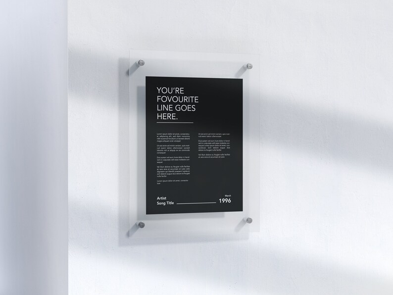 May include: A black and white poster with the text "YOU'RE FAVOURITE LINE GOES HERE."  The poster is framed in a clear acrylic frame and is hanging on a white wall.