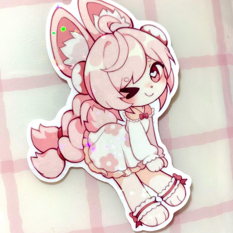 May include: A pink and white sticker of a cartoon character with bunny ears, a dress with flower details, and a long braid. The character is winking and has a heart-shaped eye. The sticker has a glittery, holographic effect.