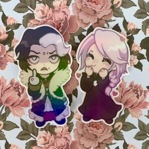 May include: Two cartoon characters, one with black and white hair and a grumpy expression, the other with pink hair and a happy expression. Both characters are wearing black and purple outfits and are depicted in a holographic style.