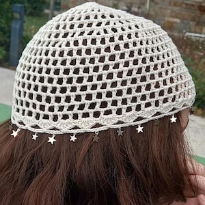 May include: A white crocheted hat with a star-shaped trim. The hat is made of a lightweight, breathable material and is perfect for warm weather.