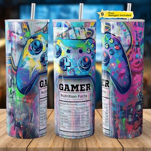 Puede incluir: Tres vasos coloridos con temática de juegos con un gráfico de un mando de videojuego. El vaso del medio tiene el texto "GAMER Nutrition Facts" con una lista de datos nutricionales para jugadores.