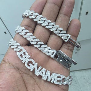 May include: A set of three ceramic vases in varying heights and shapes. The vases are glazed in a matte white finish, offering a minimalist aesthetic. The tallest vase is approximately 10 inches high.