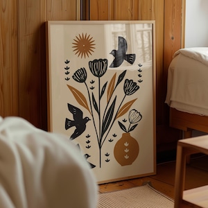 Puede incluir: Una impresión artística enmarcada con un diseño floral y de pájaros en colores negro, marrón y crema. La obra de arte incluye flores estilizadas, hojas, pájaros y un sol, todo sobre un fondo crema. El marco es de madera clara.