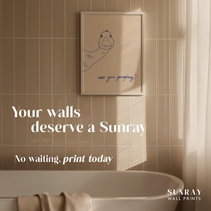 May include: A framed print featuring a blue line drawing of a duck with the text "are you pooping?" on a beige background. The image is displayed on a tiled wall above a bathtub. The text "Your walls deserve a Sunray" and "No waiting, print today" are also visible.