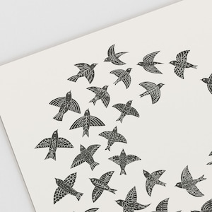 May include: A print featuring a flock of stylized black birds against a cream background. The birds are depicted in various poses, with detailed wing patterns. The artwork has a folk art aesthetic, suitable for wall decor.