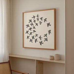 May include: A framed print showing a circular arrangement of black birds on a cream background. The artwork is encased in a wooden frame, suitable for interior decoration. The print would suit a living room or bedroom.