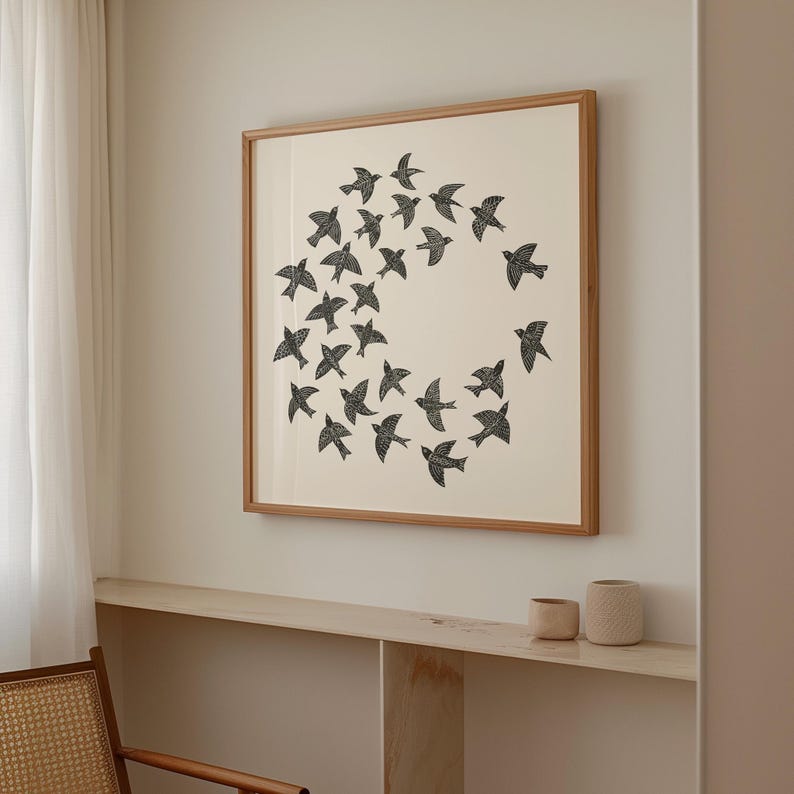 May include: A framed print showing a circular arrangement of black birds on a cream background. The artwork is encased in a wooden frame, suitable for interior decoration. The print would suit a living room or bedroom.