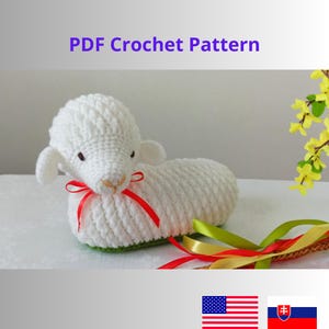 May include: PDF crochet pattern for a white crocheted lamb with red ribbon. The lamb is lying down with its head turned to the side. The pattern is available in both English and Slovak.