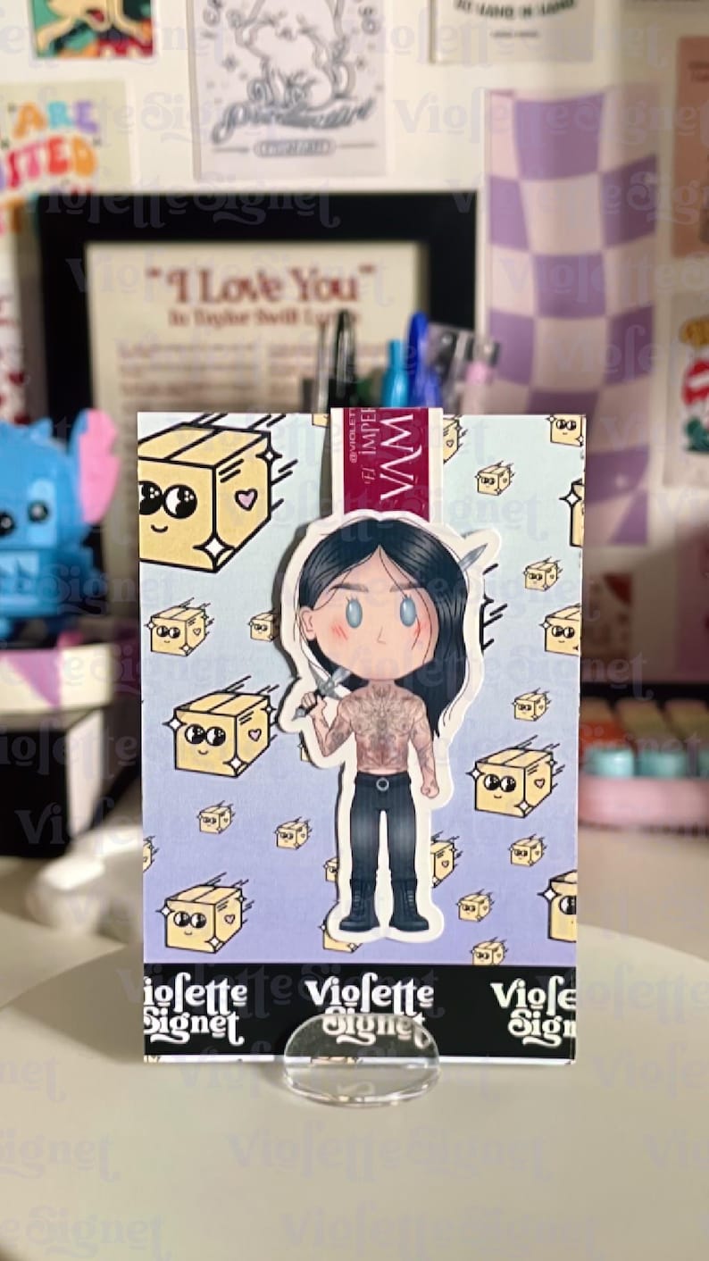 May include: A sticker featuring a cartoon illustration of a character holding a knife, with a partially exposed torso and black pants. The background has repeating images of smiling boxes. The sticker is displayed on a clear stand.